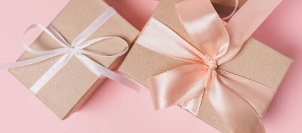 Gifts with wihte ribbon on isolated pink background, love and valentine concept - Φωτογραφία, εικόνα