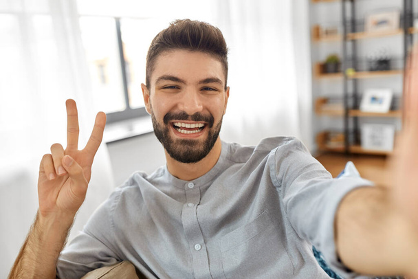 man taking selfie or having video call at home - Photo, image
