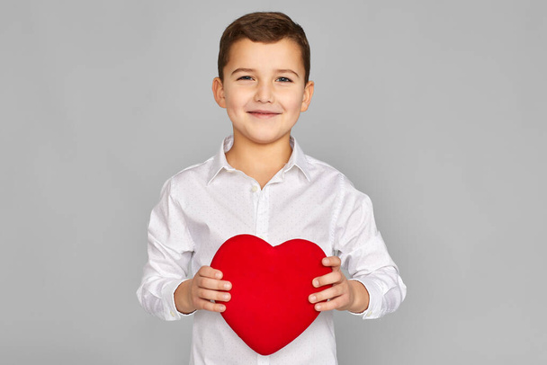 valentines day. cute little child boy holding red heart - Фото, изображение