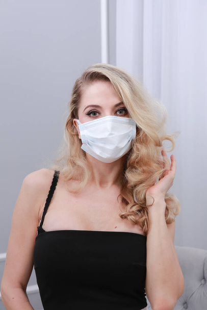 Beautiful blonde in a face mask. - Photo, Image