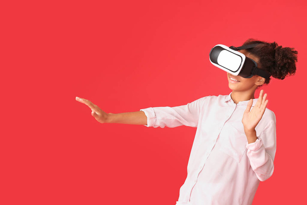 Teenage African-American girl with virtual reality glasses on color background - Photo, Image