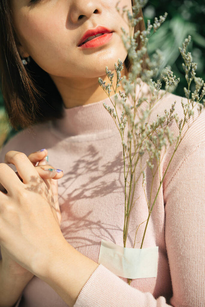 Beautiful woman short hair asian holding palea plant. Natural product concept. - Valokuva, kuva