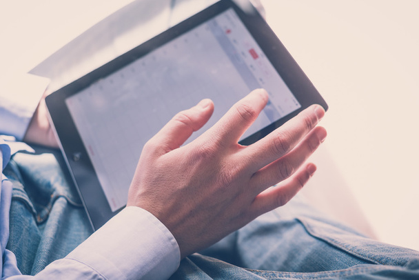 Multitasking man using tablet - Photo, Image