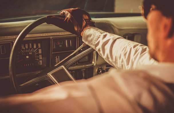 Classic Car Driver. Caucasian Men in His 40s Wearing Vintage Leather Gloves Driving His Aged Vehicle. History of Automotive Theme. - Photo, Image