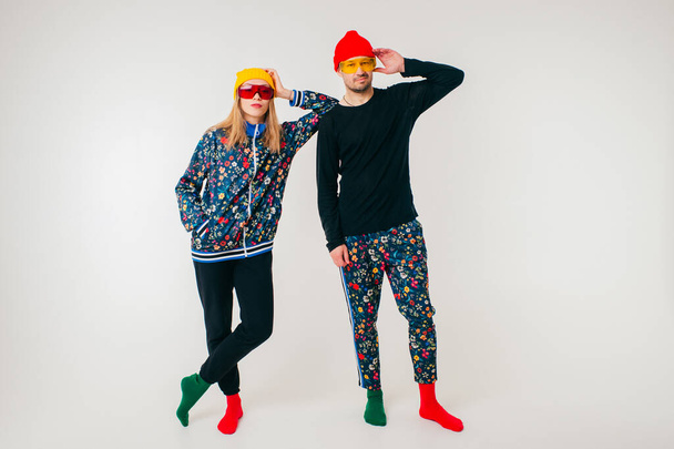Stylish couple of man and woman in colorful clothes posing over white background - Φωτογραφία, εικόνα