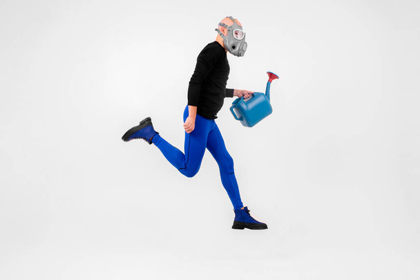 Funny strange man in respirator jumping over white background - Foto, afbeelding