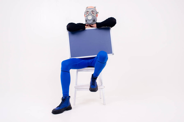 Funny strange man in respirator sitting on stepladder with a marker board  over white background - Foto, immagini