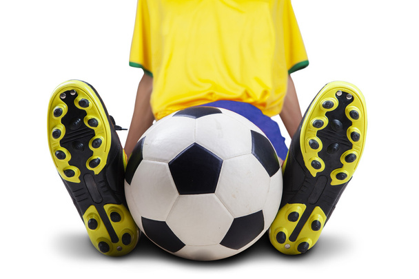 Football player sitting with ball isolated - Foto, Imagen