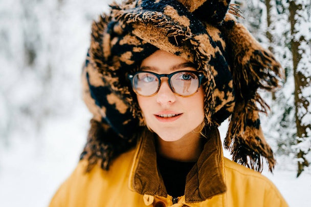 Portrait of funny young hipster girl in glasses with the turban of the scarf posing in the forest - Photo, image