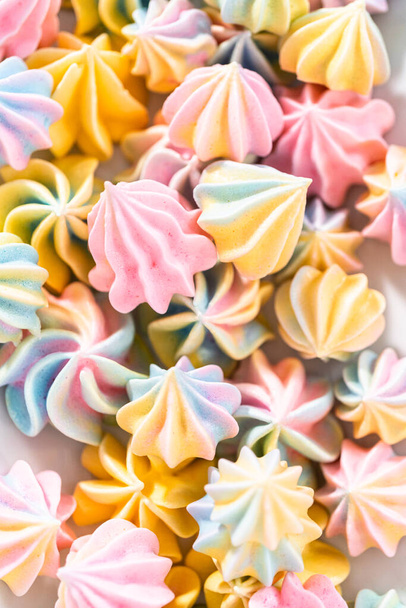 Multicolored unicorn meringue cookies on a white serving plate. - Photo, Image