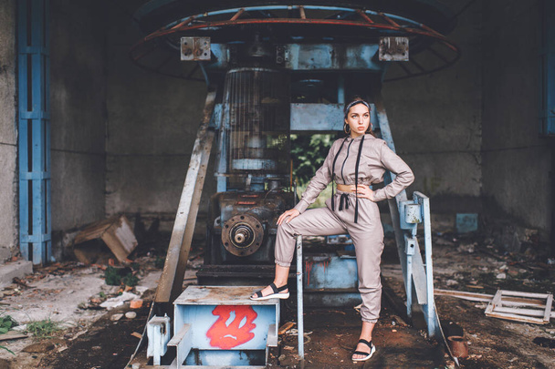 Young stylish girl posing at abandoned factory outdoor. - Foto, imagen