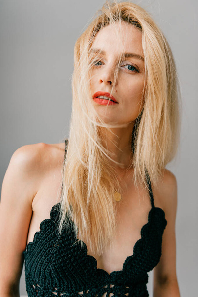 Portrait of beautiful young blonde model posing in studio - Foto, Imagem