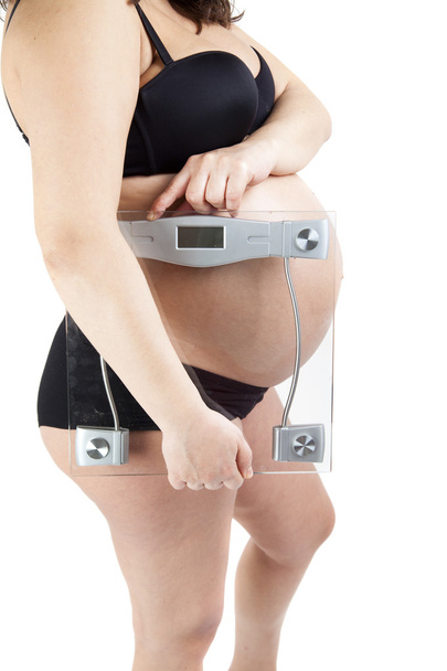 Bauch einer schwangeren Frau hält das Gleichgewicht - Foto, Bild