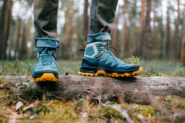 Male legs wearing sportive hiking shoes. Mens legs in trekking boots for outdoor activity. - 写真・画像