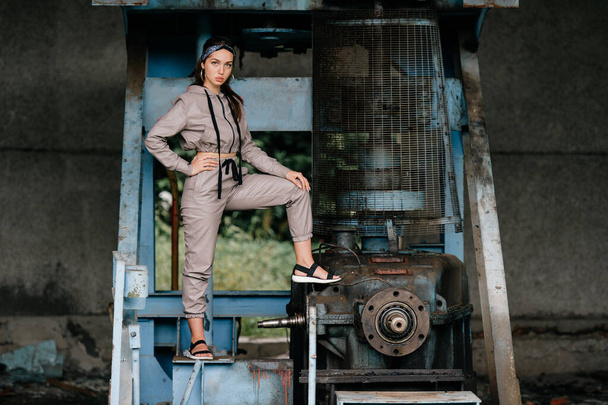 Young stylish girl posing at abandoned factory outdoor. - Foto, Imagem