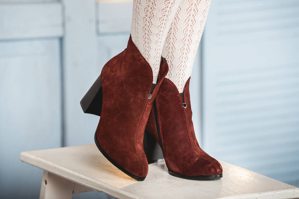 Womens brown suede fashion boots . slender female legs in white tights - Zdjęcie, obraz