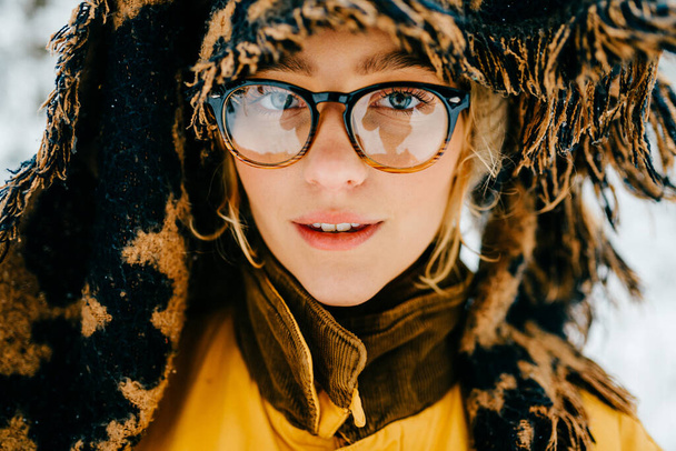 Close up portrait of funny young hipster girl with glasses and the scarf covering the head  - 写真・画像