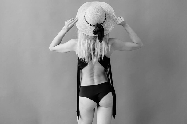 Fashion young blonde model in black underware posing in studio - Fotó, kép
