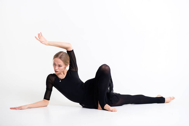 Picture of beautiful young fit woman doing sport exercises in big bright white studio - Photo, Image