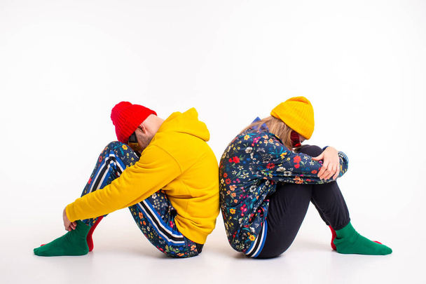 Stylish couple of man and woman in colorful clothes posing over white background - Foto, afbeelding