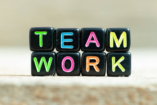 Black color block with word teamwork on wood background - Foto, Imagen