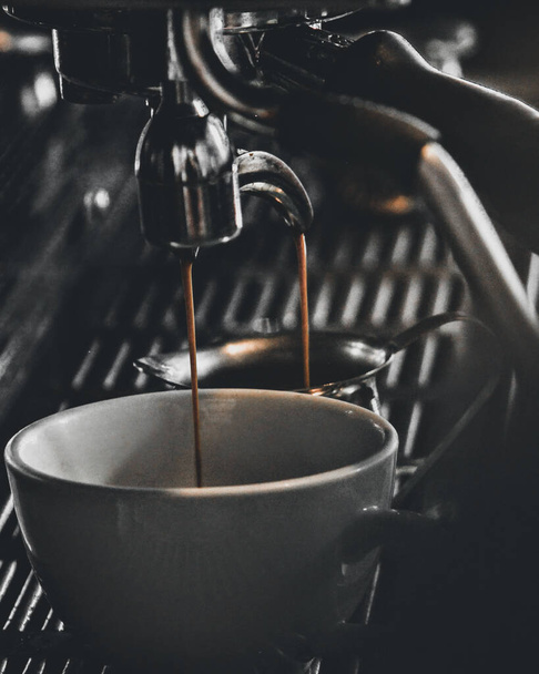 An amazing shot of a working coffee machine and filling a cup with ciffe - Foto, immagini