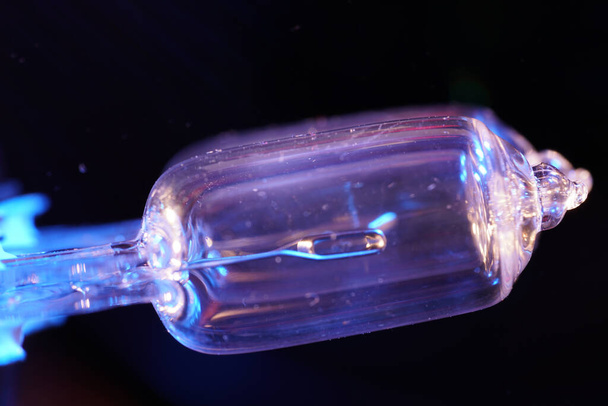 A closeup shot of an illuminated blue lightbulb - Photo, image