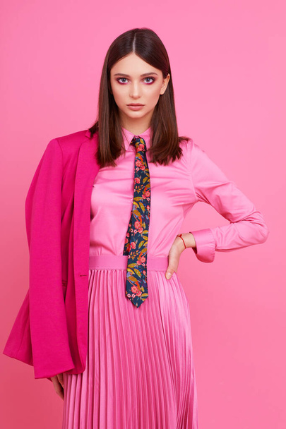 Fashion model in magenta jacket, pink skirt and shirt. Studio shot. - Valokuva, kuva