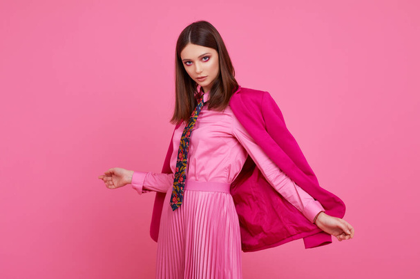 Fashion model in magenta jacket, pink skirt and shirt. Studio shot. - Zdjęcie, obraz