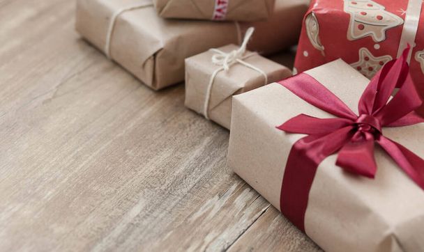 Christmas gift boxes on wooden background. New Year presents. - Foto, afbeelding