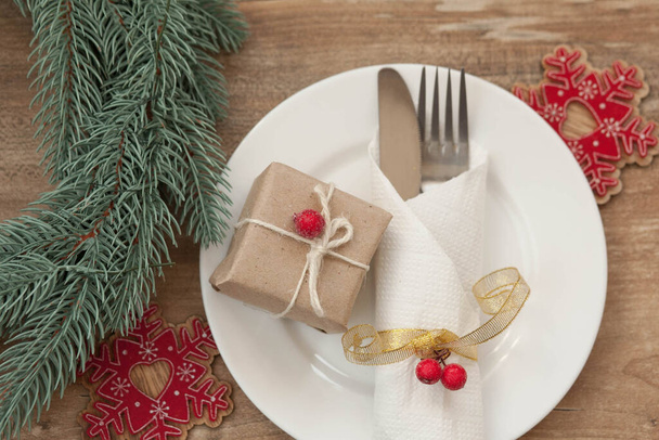 Served christmas table scratched with decorative symbols on a wooden background - Foto, imagen