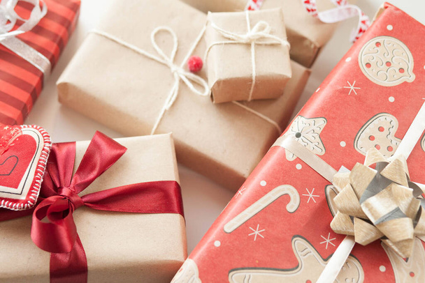Christmas gift boxes and glowing garland on wooden background. New Year presents. - Foto, afbeelding