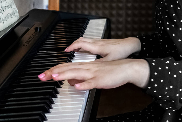Hands of a young girl pianist on the keys of a synthesizer. - Photo, Image