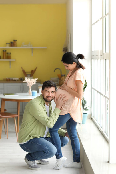 Young pregnant couple at home - Photo, Image