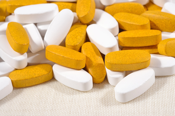 hoop van witte en gele pillen - Foto, afbeelding