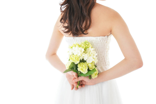Young woman in dress having a bouquet - Фото, изображение