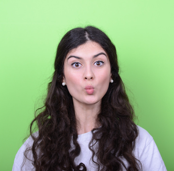 Portrait of girl with funny face against green background - Фото, изображение