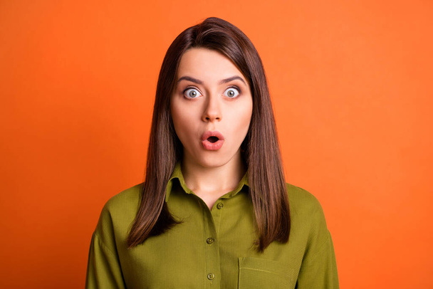 Photo of cute excited girl look camera shocked face open mouth wear green shirt isolated orange color background - Φωτογραφία, εικόνα