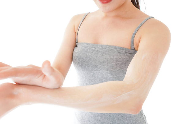 Young woman using a sunscreen cream - Фото, изображение