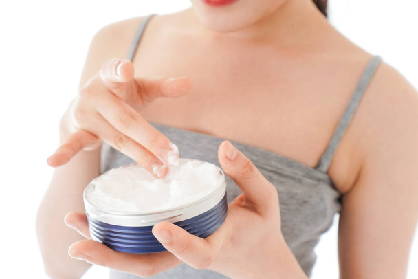 Young woman using cream to the face - Photo, Image
