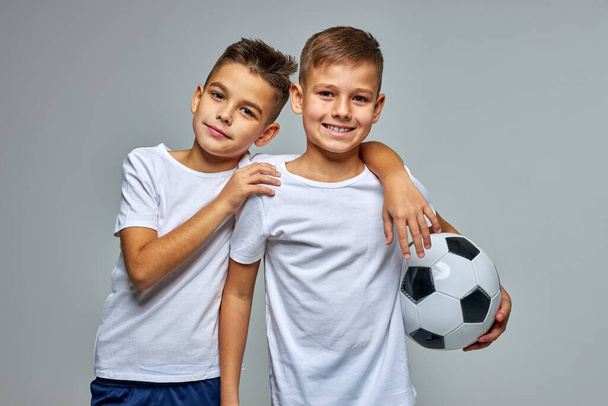 friendly active boys with soccer ball in hands - Photo, image