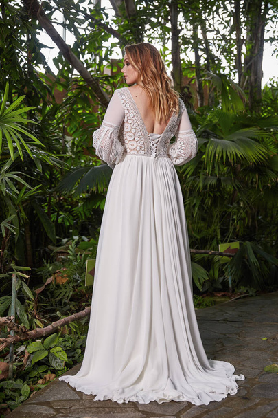 Beautiful woman plus size model bride fashion model blond hair bright makeup  wear long silk white dress lace bridal ceremony wedding espousal in blooming garden party marriage accessory. - 写真・画像