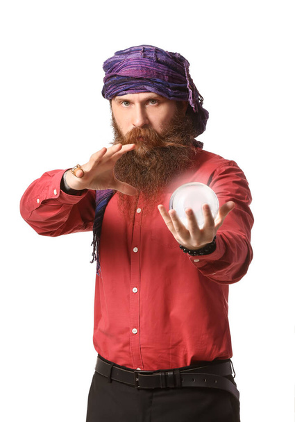 Male fortune teller with crystal ball on white background - Photo, Image