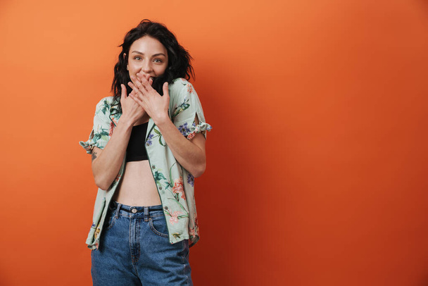 Beautiful young surprised woman isolated over orange wall background - Foto, immagini