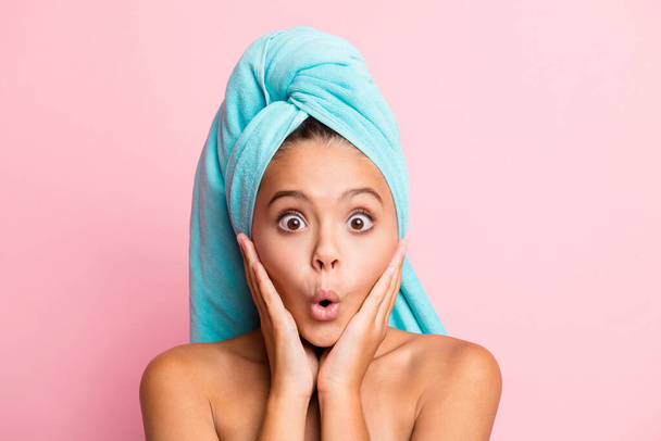 Close up portrait of cute impressed girl wear turquoise towel on head hands cheeks open mouth isolated on pastel pink background - Φωτογραφία, εικόνα