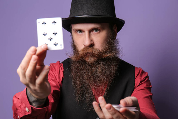 Male magician with cards on color background - Photo, Image