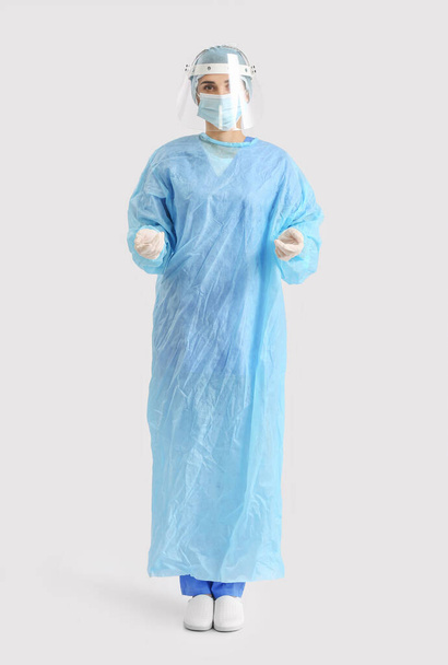 Portrait of female surgeon on light background - Фото, изображение