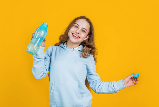 feel thirsty. protein and vitamin bottle. happy and healthy teen girl. fit child drink water after training. sport is life. athletic kid care of water balance in body. hydration. quench thirst - Fotoğraf, Görsel