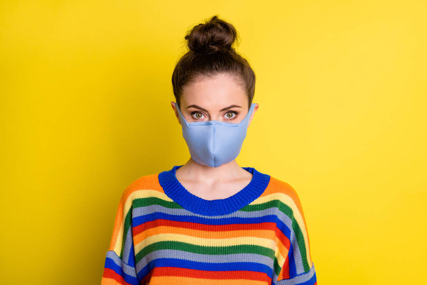 Portrait of brunette girl wear blue mask from corona rainbow sweater isolated on bright yellow color background - Foto, immagini