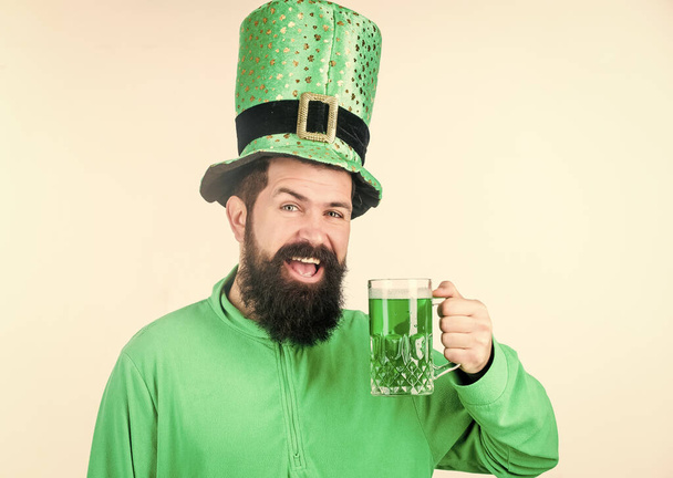 Colored beverage patricks holiday. Green color part of celebration. Irish beer pub. Global celebration irish culture. Man bearded hipster hat patricks day drink pint beer. Saint patricks day holiday - Valokuva, kuva